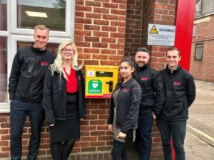 Elliotts employees with one of the new 24 hour access defibrillators